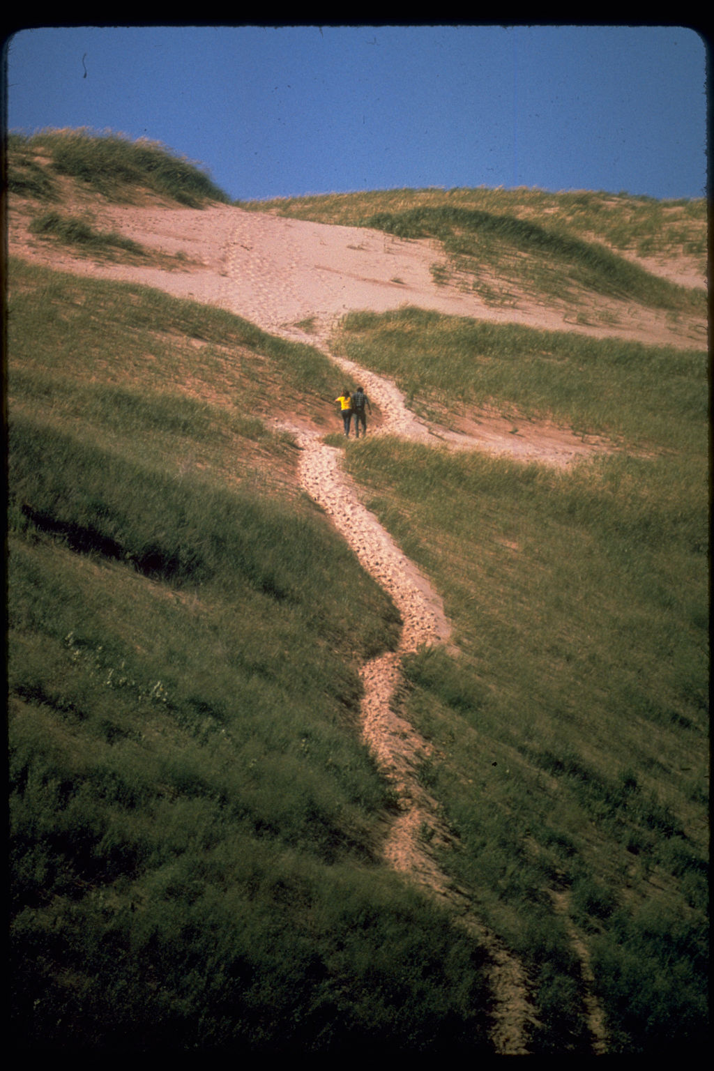 two people climbing up a path at Sleeping Bear Dunes